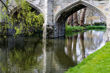 Fototapeta premium Reflections in the river, under the archways
