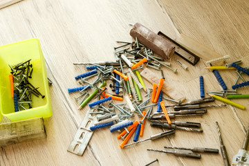 Pile of dowels and screws on the floor, close-up