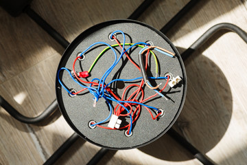 Chandelier with wires on the floor, preparation to installation