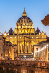Vatican City by night. Illuminated dome of St Peters Basilica and St Peters Square at the end of Via della Conciliazione. Rome, Italy