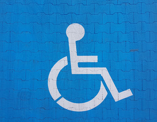 Road marking sign on a blue background denoting parking for a disabled vehicle. The convenience of parking a vehicle. The journey of people with disabilities in a wheelchair. Free space for the needy