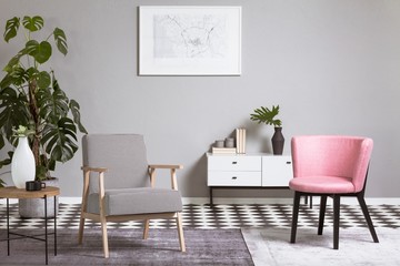 Pastel pink chair in beige and grey living room interior