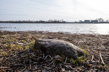 large rock in sand in countryside