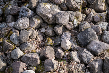 large rock in sand in countryside