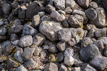large rock in sand in countryside