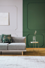 Abstract oil painting on grey wall with moldings in contemporary living room interior with grey...