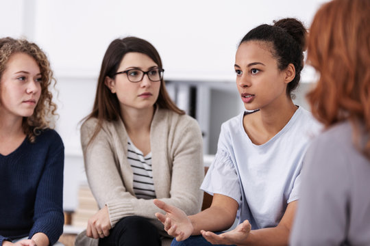 women supporting each other during psychotherapy group meeting