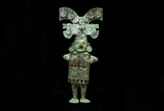 Pre-columbian copper men figure from Lambayeque ancient Peruvian culture. Pre inca handcrafted metallic piece made by ancient civilization.