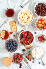 Fototapeta na wymiar Summer berries strawberries, blueberries, sweet cherries in vases on the table. Top view