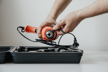 The worker assembles a drill bit. The concept of work, hiring a professional. Preparing for work, drilling, renovation at home.