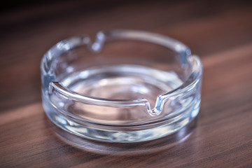 Glass Ashtray closeup on wooden table