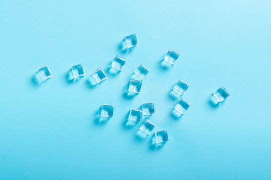 Ice Cubes On Blue Background. Flat Lay, Top View