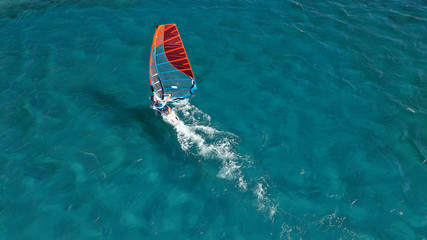 Aerial photo of surfer cruising in high speed in Mediterranean destination bay with deep blue sea © aerial-drone