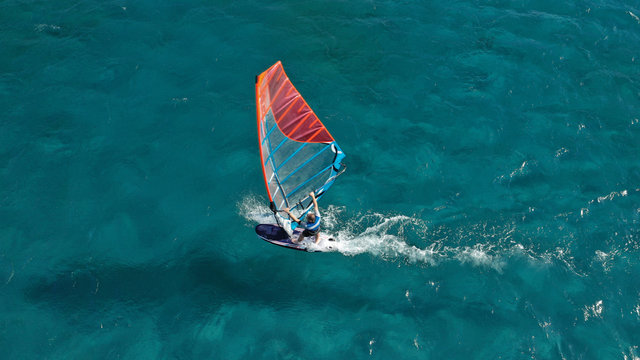 Aerial photo of surfer cruising in high speed in Mediterranean destination bay with deep blue sea