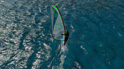 Aerial photo of surfer cruising in high speed in Mediterranean destination bay with deep blue sea