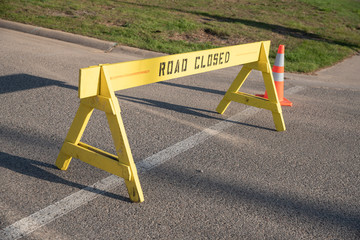 barricade sign says road closed