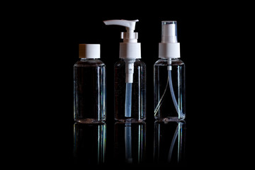 Blank glass cosmetic bottles on black background for print design and mock up