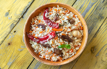 Bowl of pilaf on the wooden table