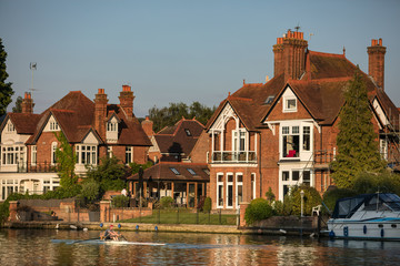Rowers on the river Thames at Marlow on a warm summer evening in Buckinghamshire, UK