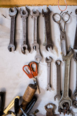 A set of keys and tools for repair hang on the wall