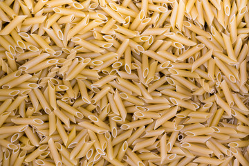 A lot of pasta curls spiral poured in bulk.