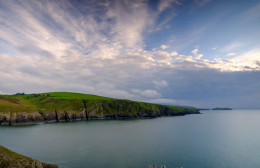 Evening light on the Ceredigion cliffs and Cardigan Island from Mwnt, Wales