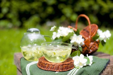 Cup of jasmine tea and jasmine flowers