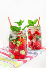 Two glasses with drink of fresh ripe berries on beautiful towel