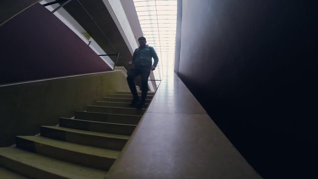 Man in dark boots and jeens descends down the stairs tourist travel city outdoors people street tourism beautiful building europe guy lifestyle urban view architecture slow motion