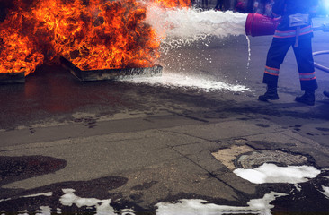  firefighter extinguishes the fire with smoke.