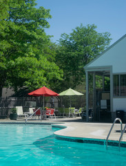 Pool with Tables, Chairs, and Umbrella