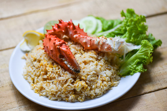 Fried Rice crab seafood egg lemon and cucumber on white plate wooden table background - Crab claw