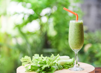 Vegetable juice smoothie summer and fresh celery stalk on wooden board with nature green