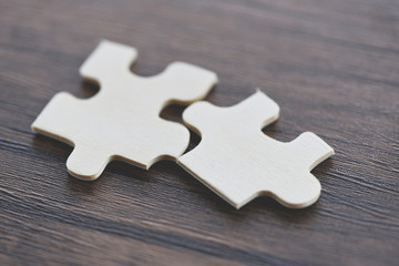 jigsaw puzzle on wooden background top view - Two jigsaw piece connecting