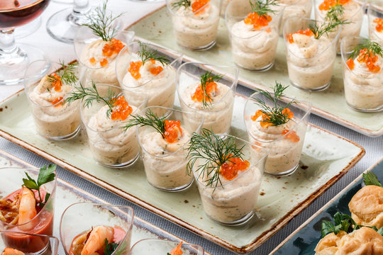 Delicious Appetizers With Red Caviar, Shrimp And Cheese Mousse In Glass Cups On Banquet Table. Gourmet Food Close Up, Snack, Antipasti, Seafood Platter