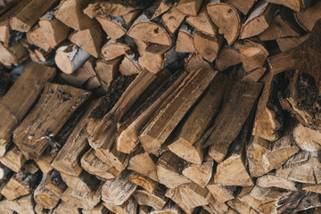 Chopped wood in the stack. Wooden firewood logs superimposed on each other.