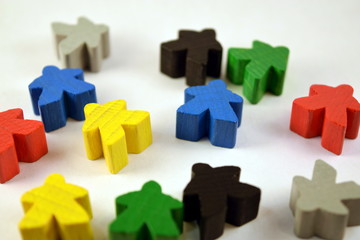 Colorful meeples on white background. Table top strategy board games. Eurogames.