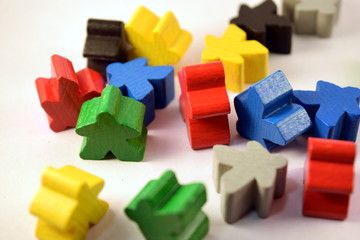 Colorful meeples on white background. Table top strategy board games. Eurogames.