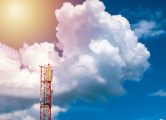 communication tower on bright blue and cloudy sky background