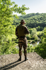 Special force soldier on the watch on the battlefield mission airsoft