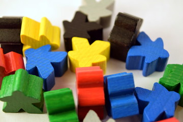 Colorful meeples on white background. Table top strategy board games. Eurogames.
