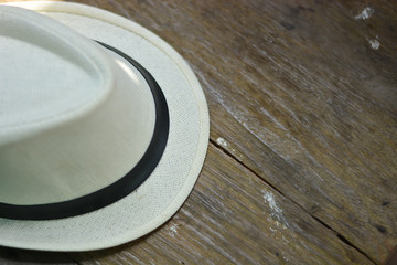 Cream-colored men's hats placed on wooden floors