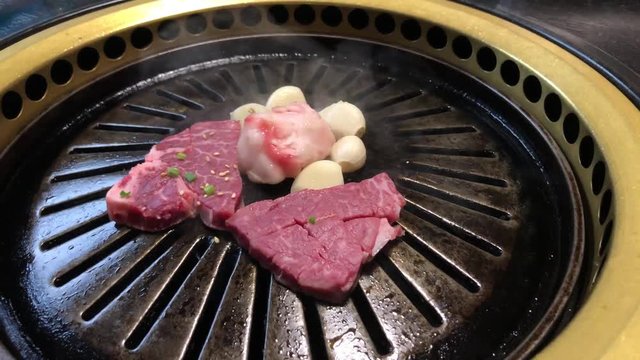 raw beef grilled in a japanese style barbecue restaurant "yakiniku"