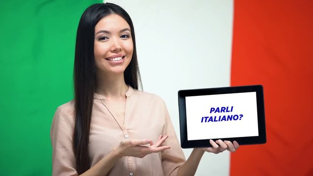 Woman holding tablet with do you speak italian phrase, app for learning language
