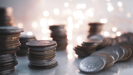 rows of money coins on light bokeh for finance , money , investment and business concept background
