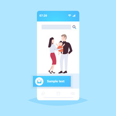 father mother and newborn baby having fun together happy family parenthood concept man woman playing with newborn child smartphone screen online mobile application flat full length