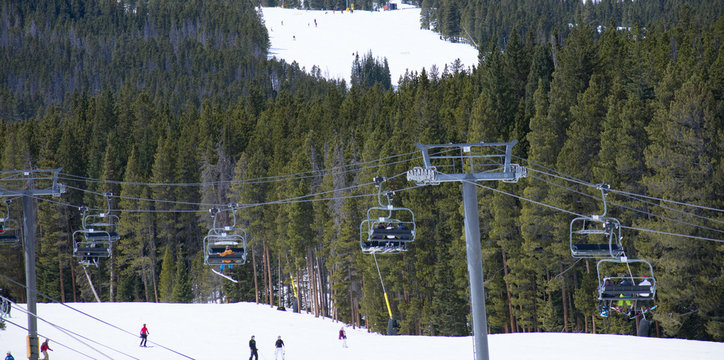 Skiers Riding Up A Ski Lift - Multi-chair Lift In Denver 