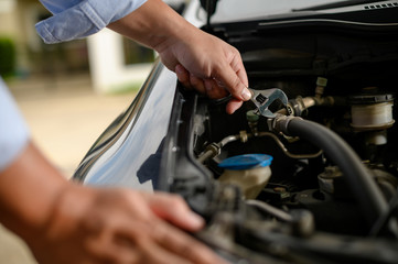 Obraz premium Repair service car Auto mechanic working in garage car mechanic with wrench in garage