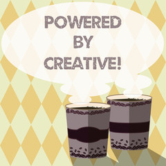 Word writing text Powered By Creative. Business concept for characterized by originality of thought or inventiveness Two To Go Cup with Beverage and Steam icon Blank Speech Bubble photo