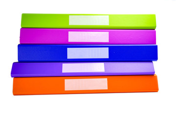 File Folder Binder stack of multi color on table in office.